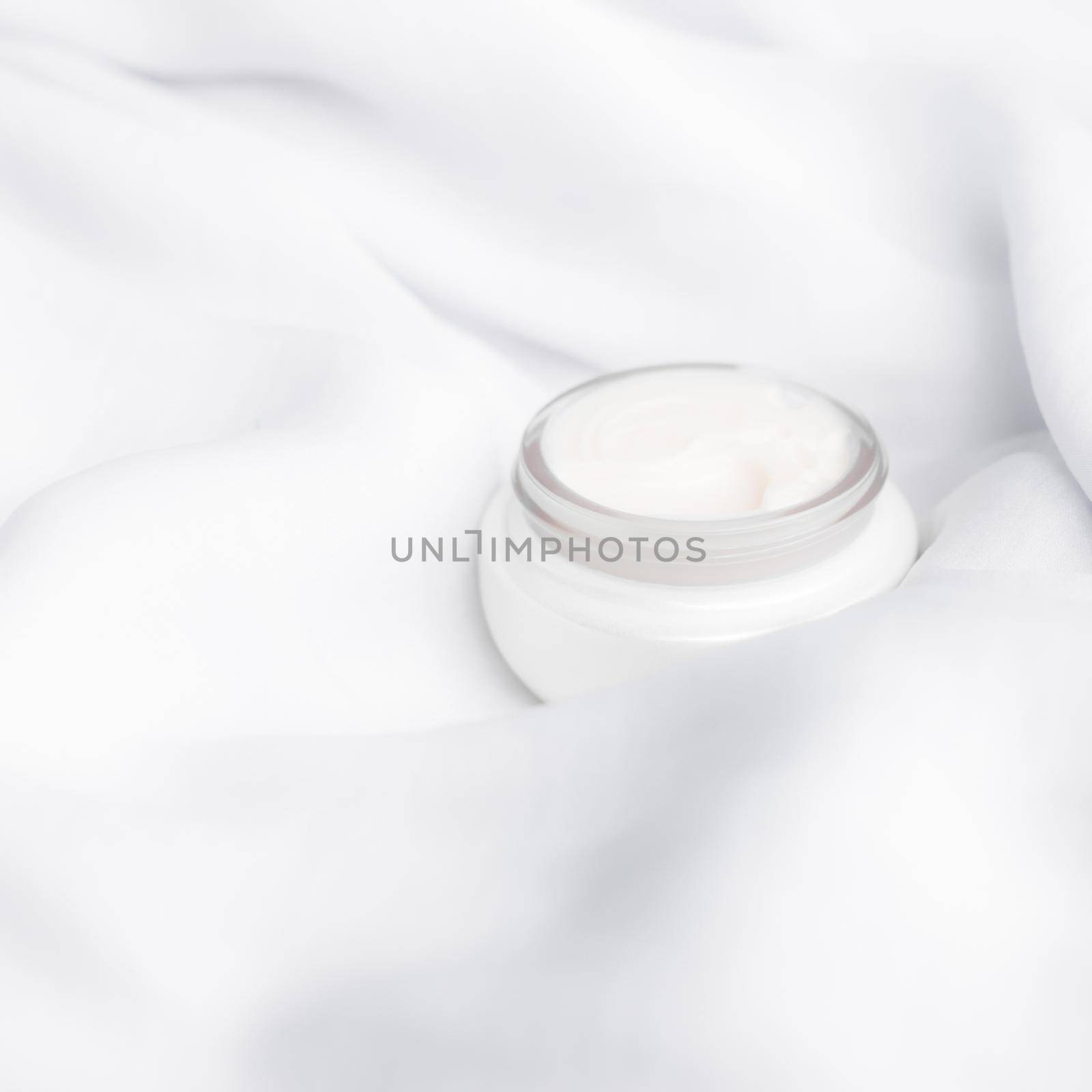 luxury face cream on soft silk - anti-aging, cosmetic and beauty styled concept