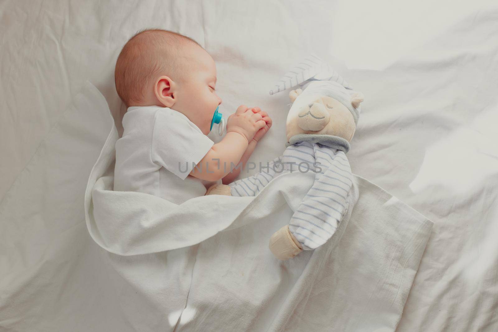 The baby is sleeping in his crib. Happy baby dream. A happy child. Children's article. Copy Space