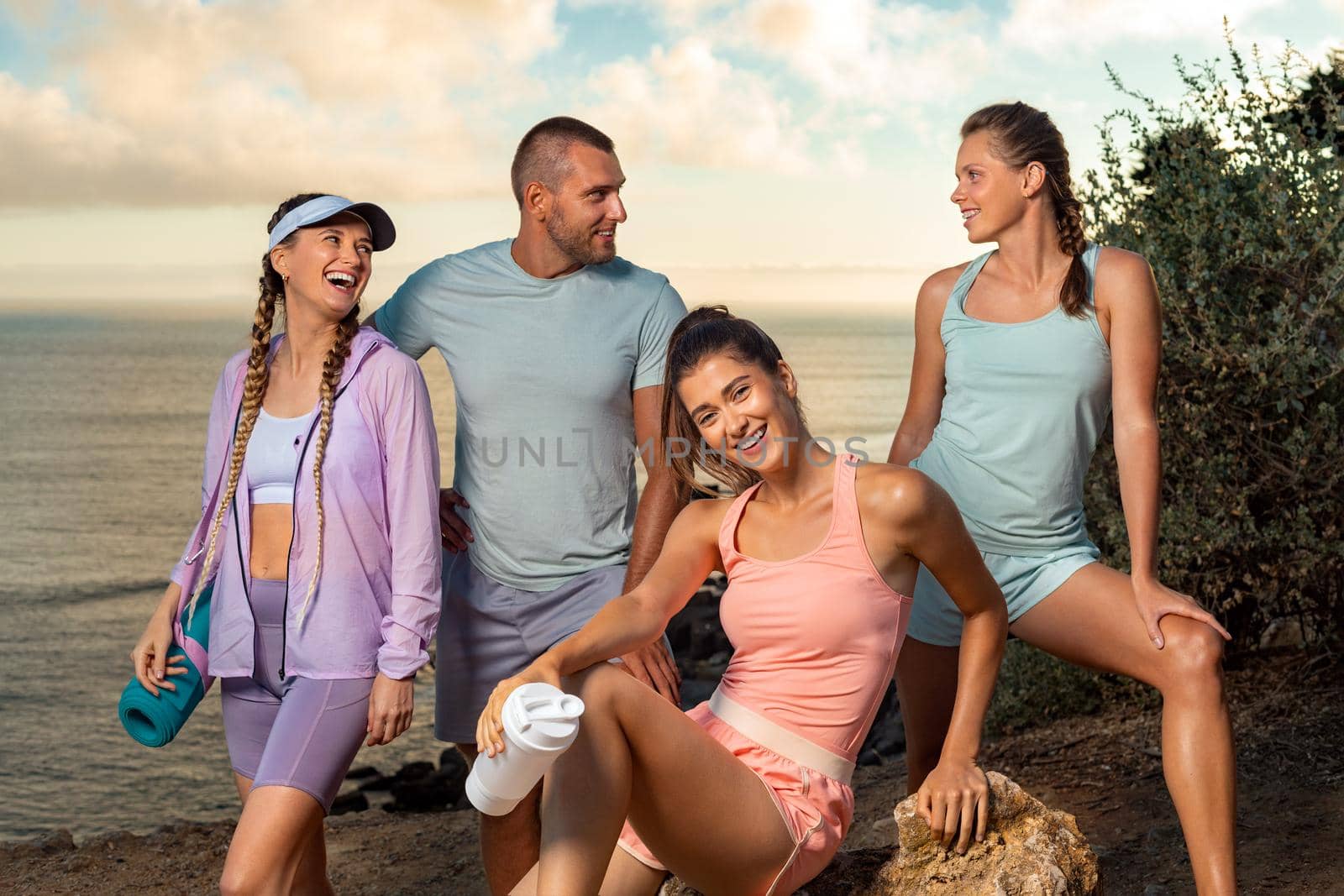 Group of athletes rest after running. Certified instructor and his fitness team. Premium high resolution photo of smiling women and man. by MikeOrlov