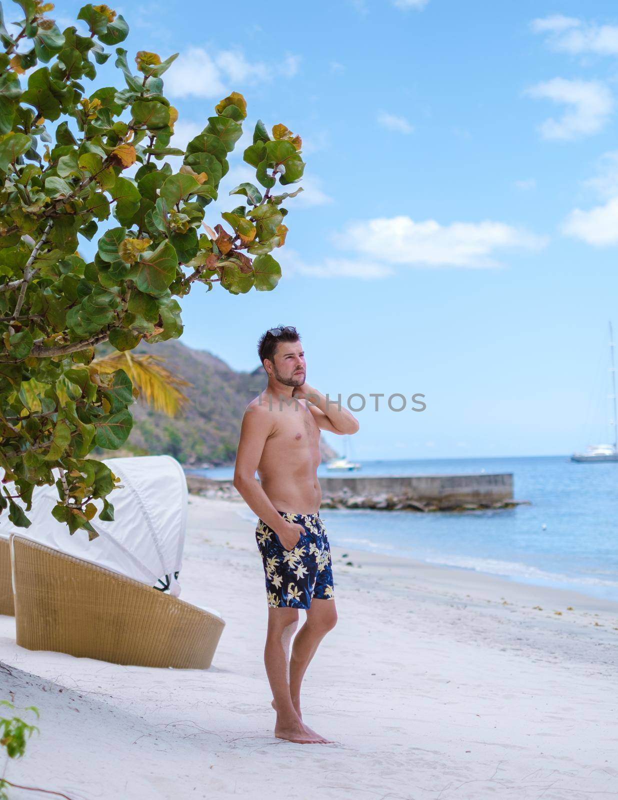 young men in a swim short on vacation in Saint Lucia, luxury holiday Saint Lucia Caribbean, men on vacation at the tropical Island of Saint Lucia Caribbean. sugar beach St Lucia Caribbean