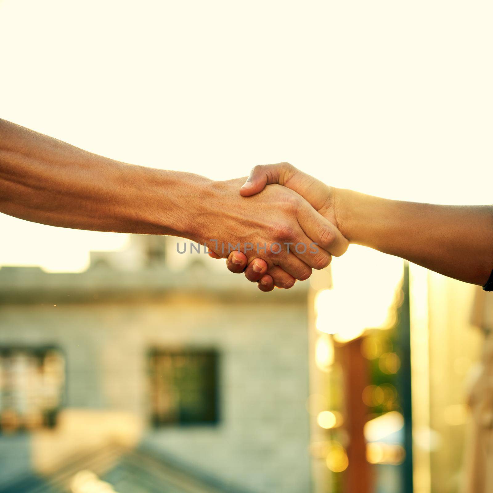 Stronger as a unit. two men shaking hands outdoors. by YuriArcurs