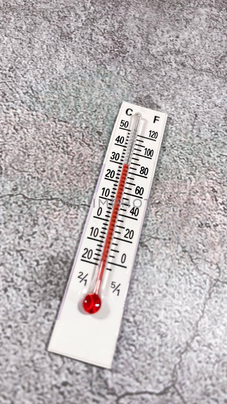 thermometer on the grey background by yilmazsavaskandag