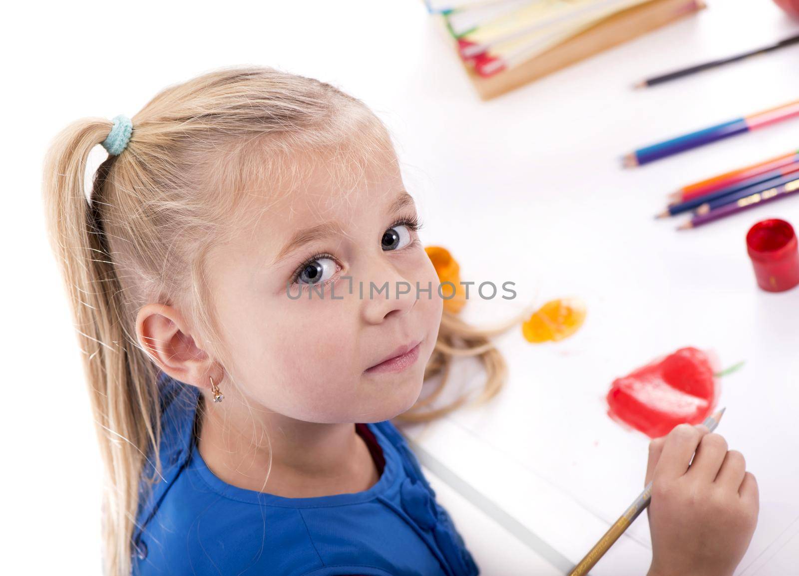 Children's hobbies, creativity, a little girl in a blue dress draws paints by aprilphoto
