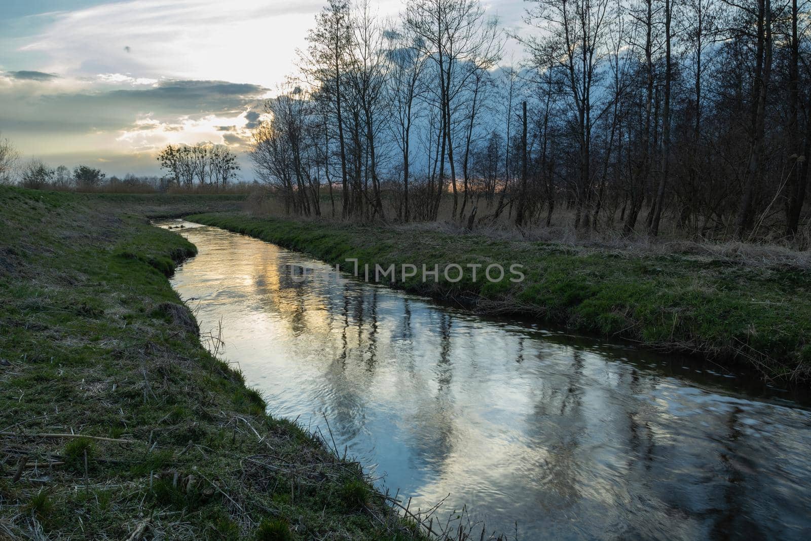 Reflection of the evening sky in a small river, Stankow, Poland