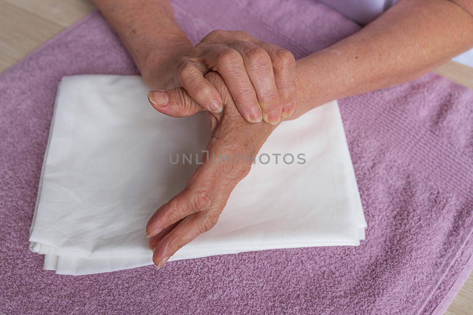 step by step instructions step 3. Close-up of a woman's hand massaging her hand by Ramanouskaya