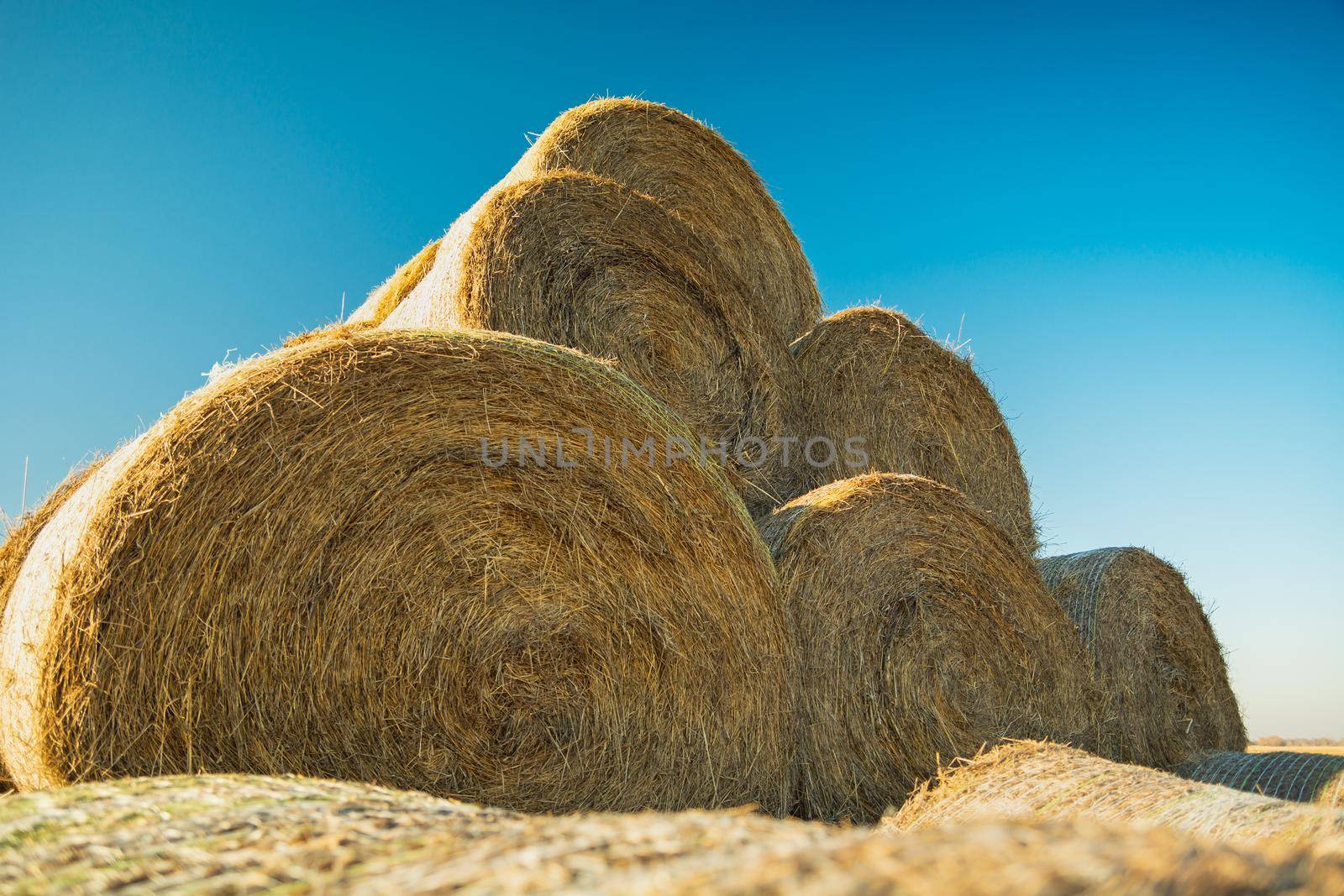 Pyramid of hay bales against the blue sky