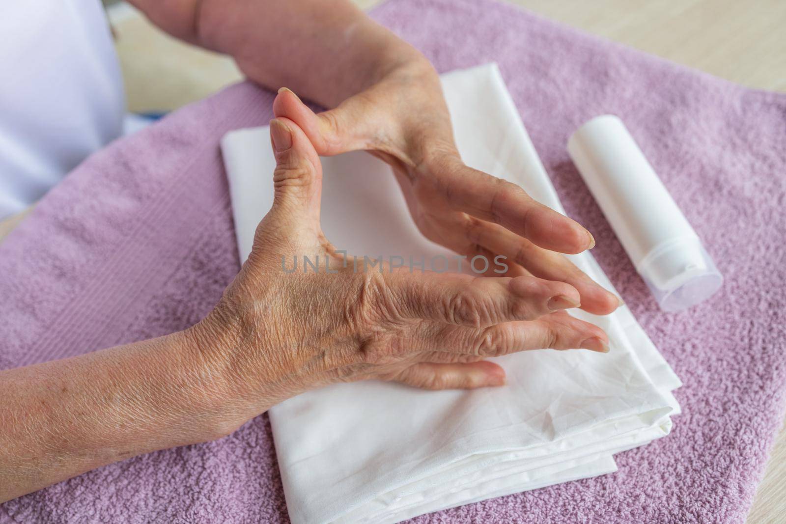 massage for arthritis and neurological diseases. Self-massage of hands of an elderly woman with arthritis. Health of the fingers and joints of the hands. Prevention of neurological diseases