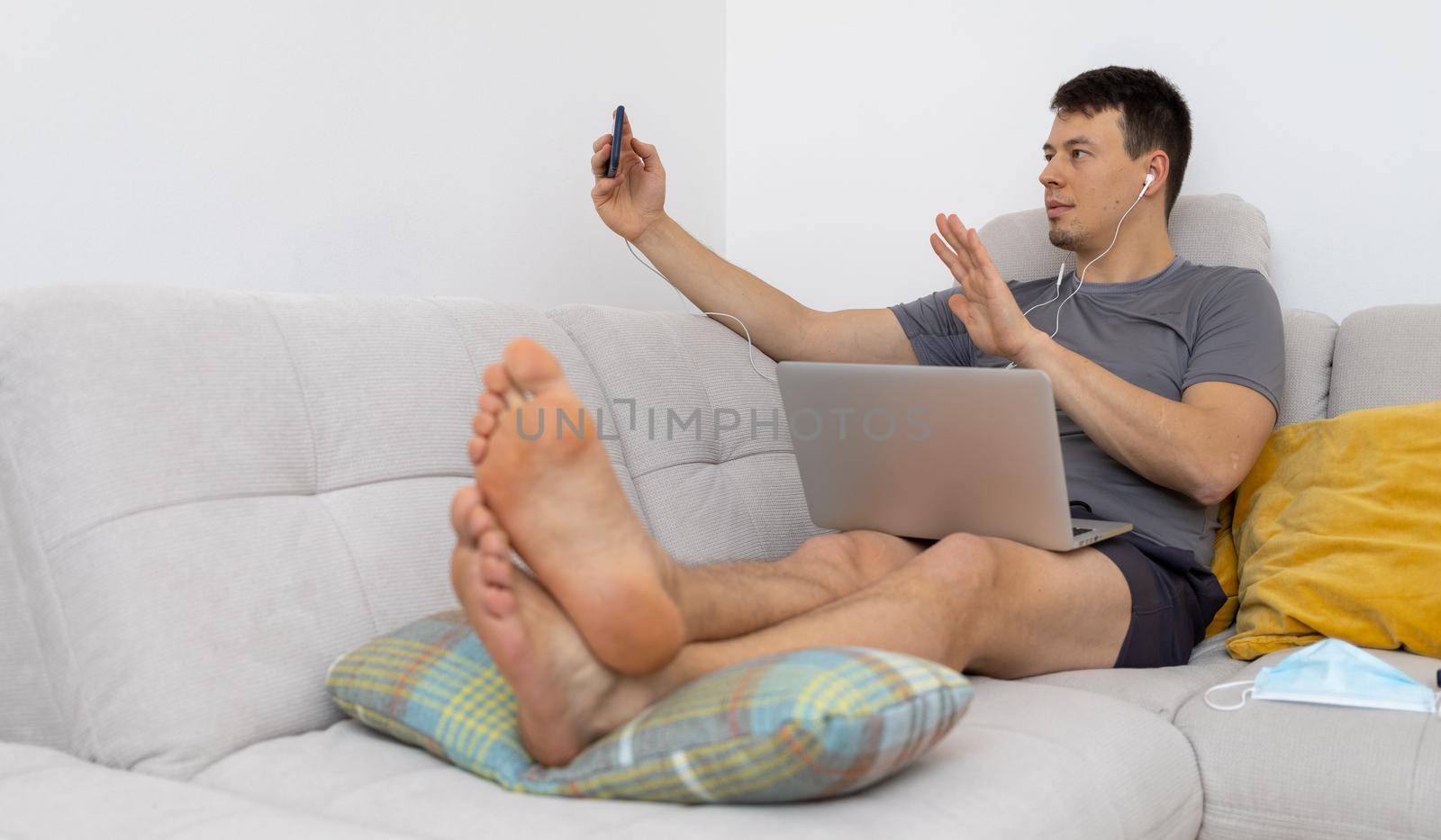 young man in headphones watching at mobile phone. High quality photo