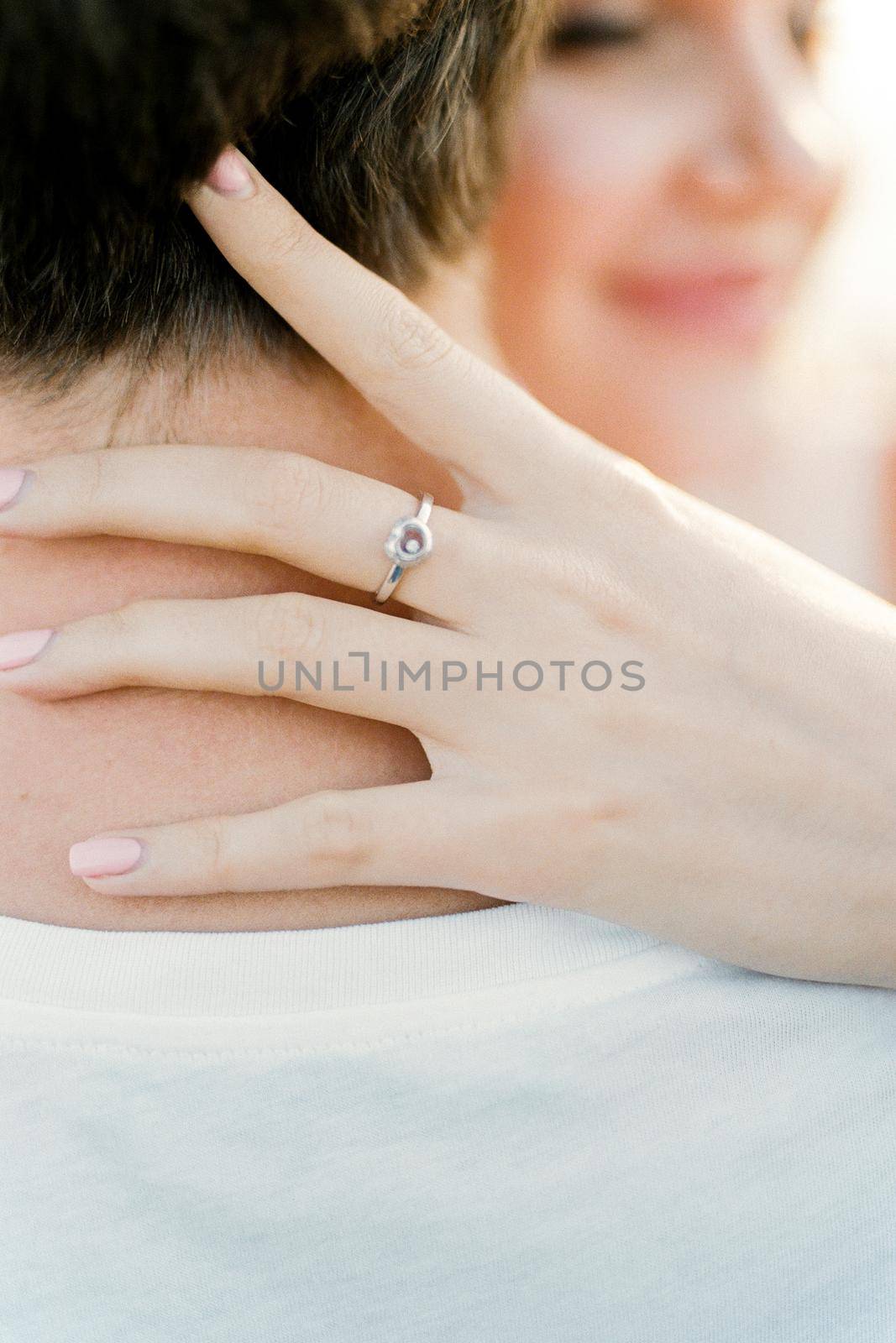 Woman hand on a man neck. Close-up. High quality photo