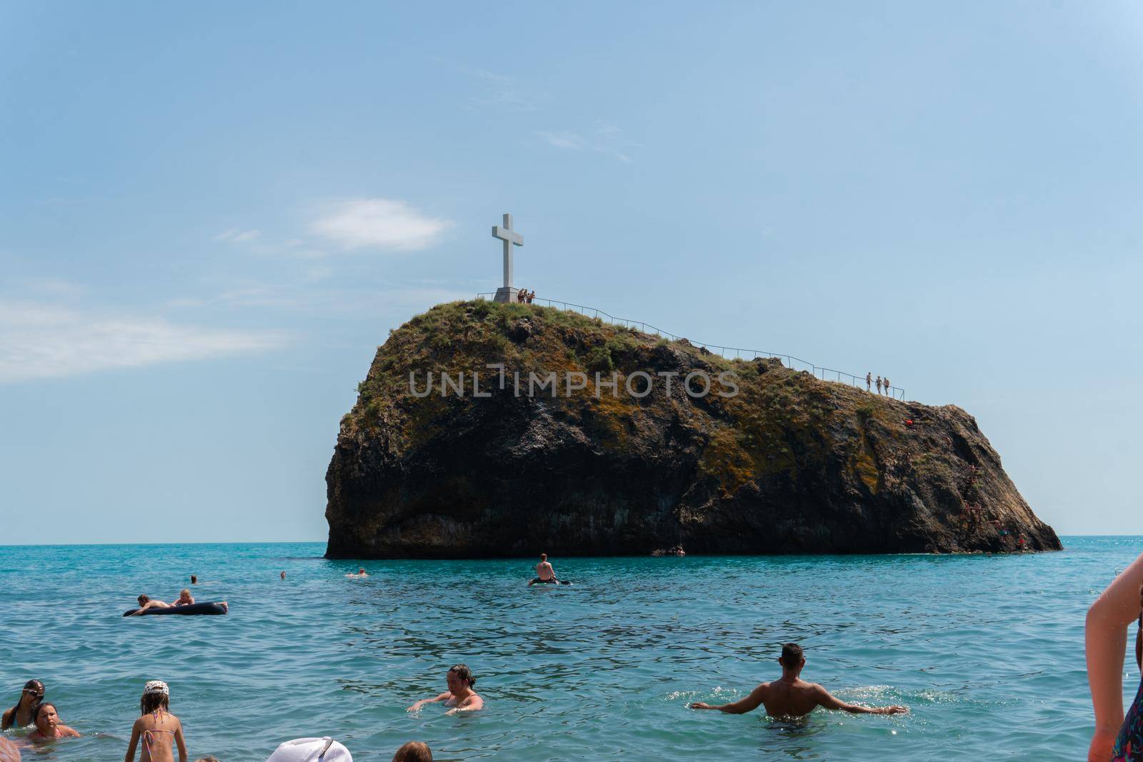 People bathe Cape cross Crimea Fiolent sea summer rock monastery, for near sunny from island from coastline tourism, mountain europe. Panoramic adventure church,