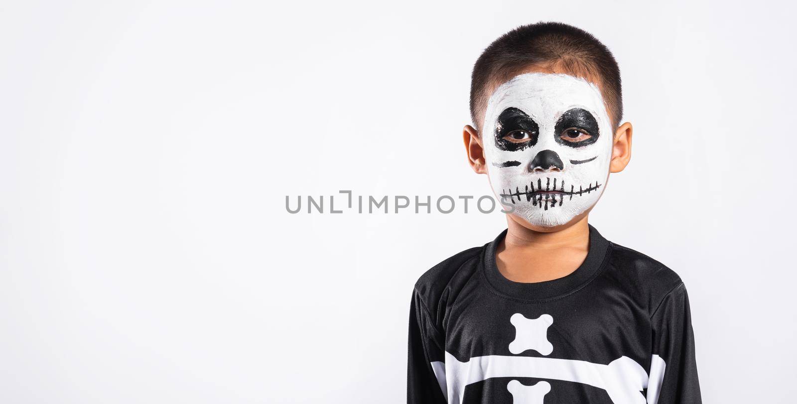 Halloween Kid. Child man horror face painting make up for ghost scary, Portrait of Asian little kid boy wearing skeleton costume studio shot isolated white background, Happy halloween day concept