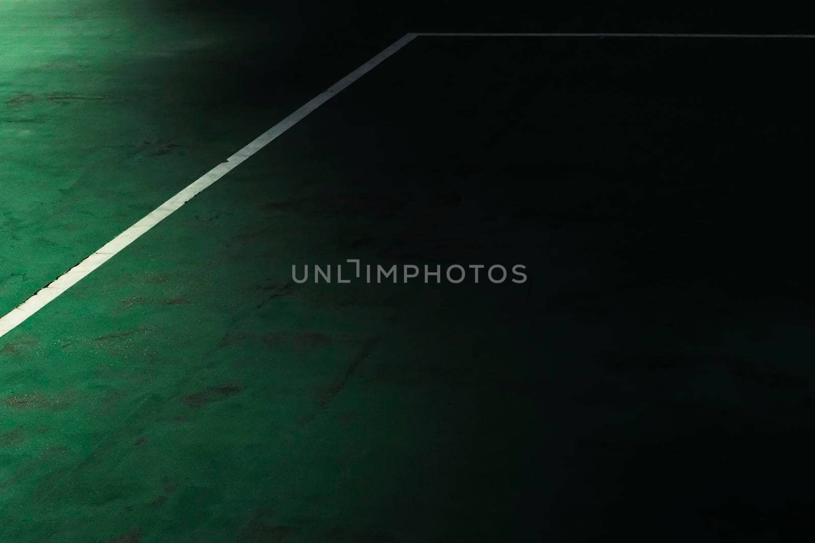 Abstract background with white line and green floor of a tennis field. Light and shadow concept.