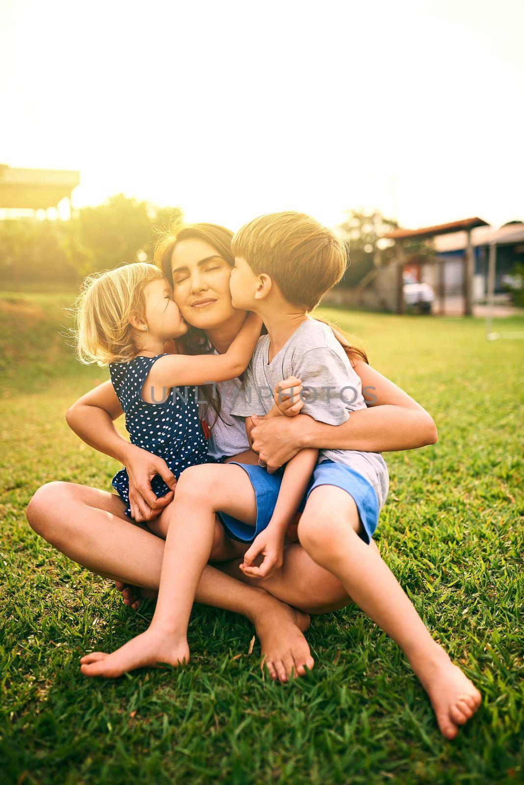 We love you lots, Mom. a mother bonding with her two adorable little children outdoors