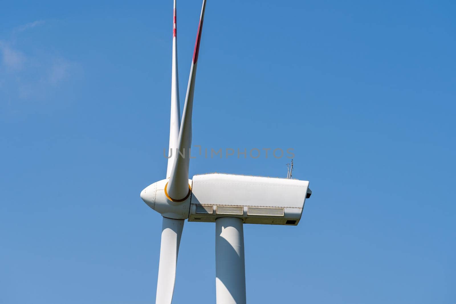 Panoramic view of wind farm or wind park, with turbines for generation electricity on sunny summer day. Green energy concept. Eco renewable energy power. Close up