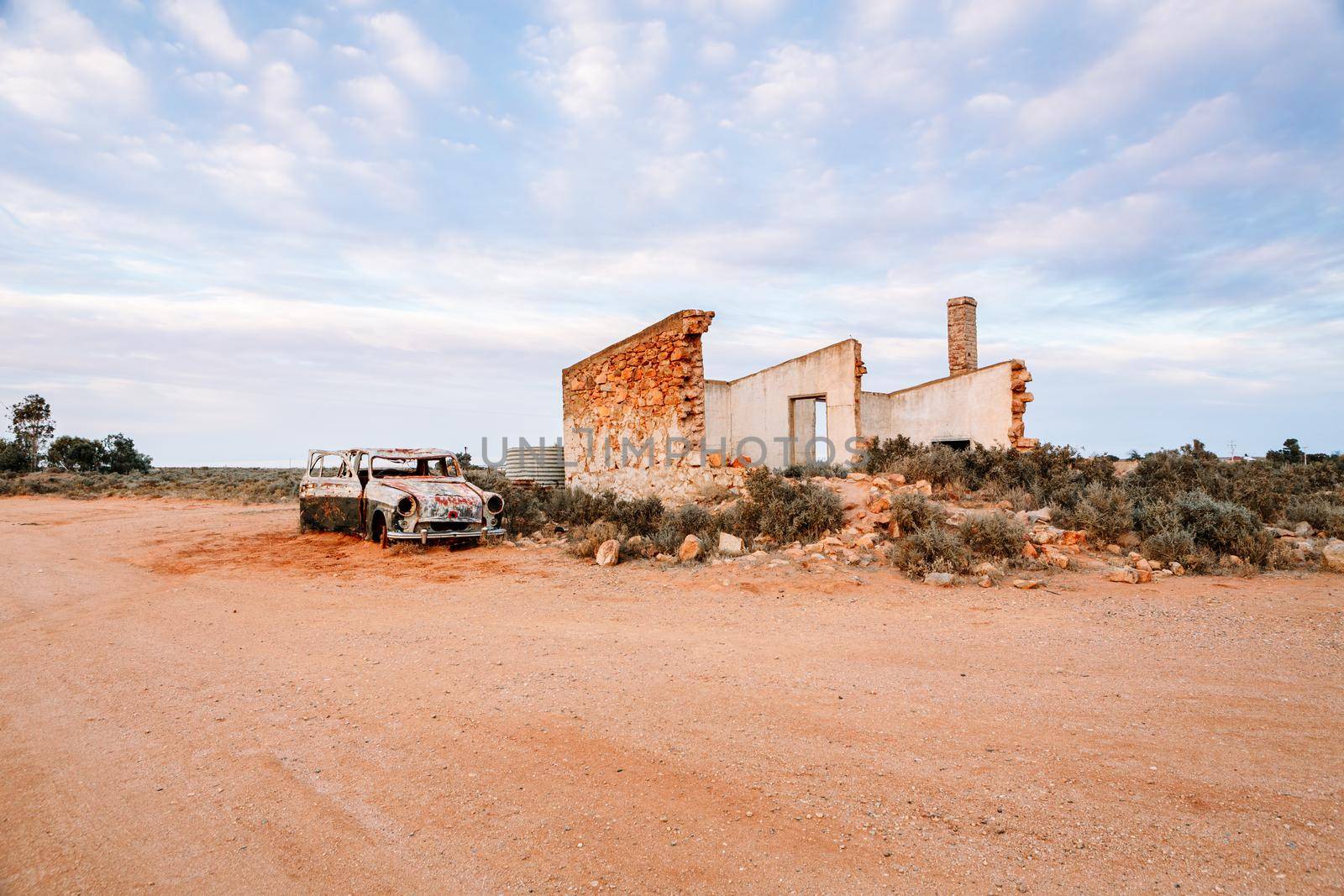Crumbling old stone homes and rusting cars in outback Australia by lovleah