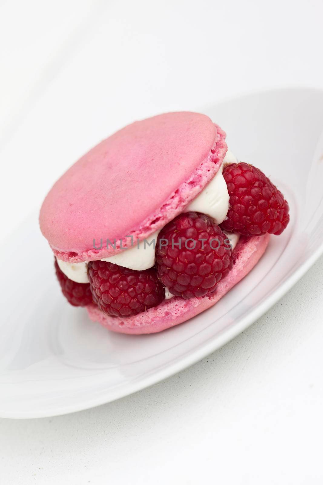 Close up of a Raspberry macaroon and Chantilly cream