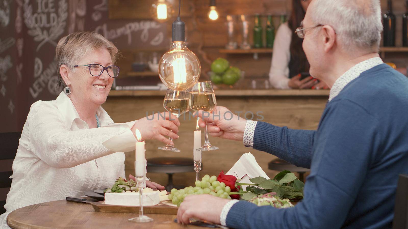 Senior couple making a toast for their lationship with wine. Relaxed couple. Dinner in restaurant.