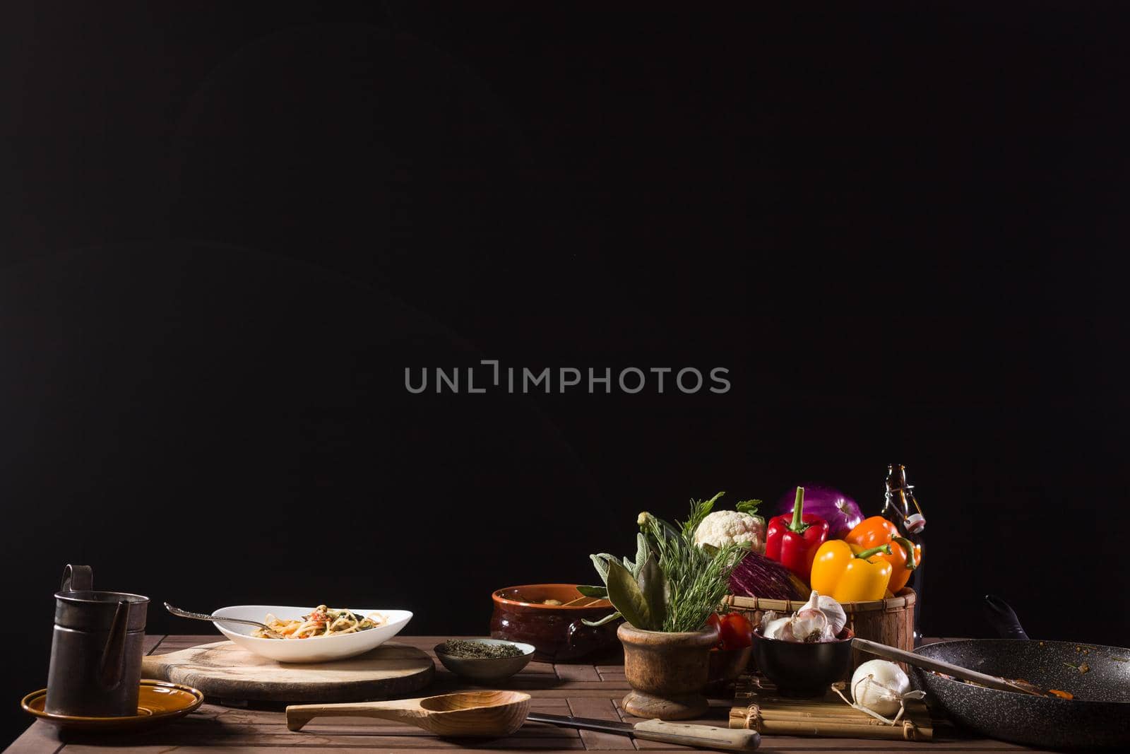 Dish of Italian pasta called Spaghetti and fresh Vegetables on the kitchen table of a restaurant kitchen