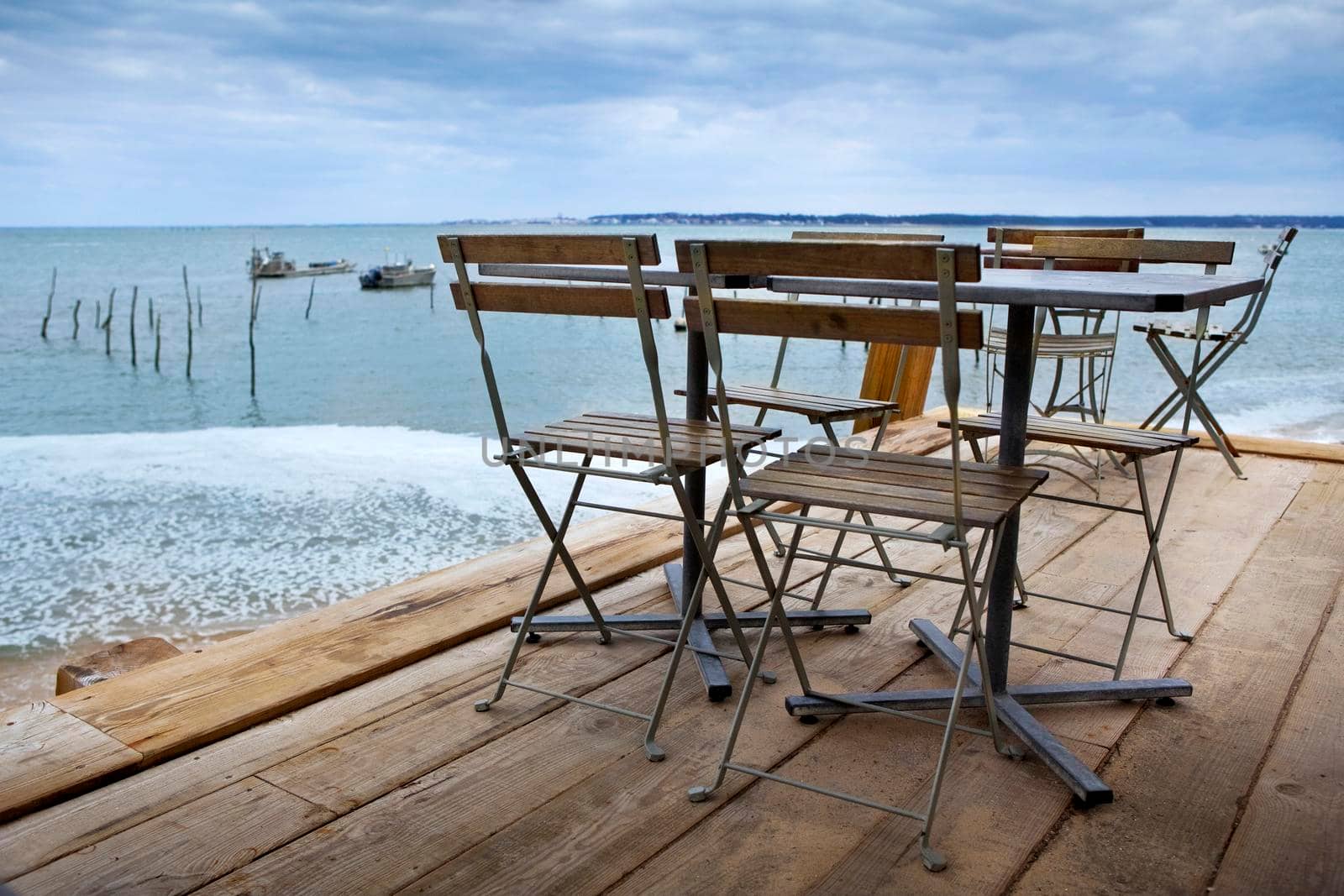 Table set up of a French bistro on a wooden terrace near Bordeaux
