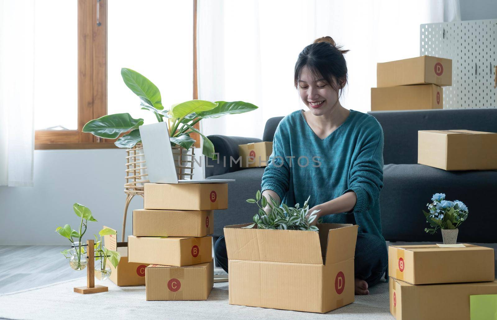 Young woman small business owner working at home office. Online marketing packaging delivery, startup SME entrepreneur or freelance woman concept. Small business owener by wichayada