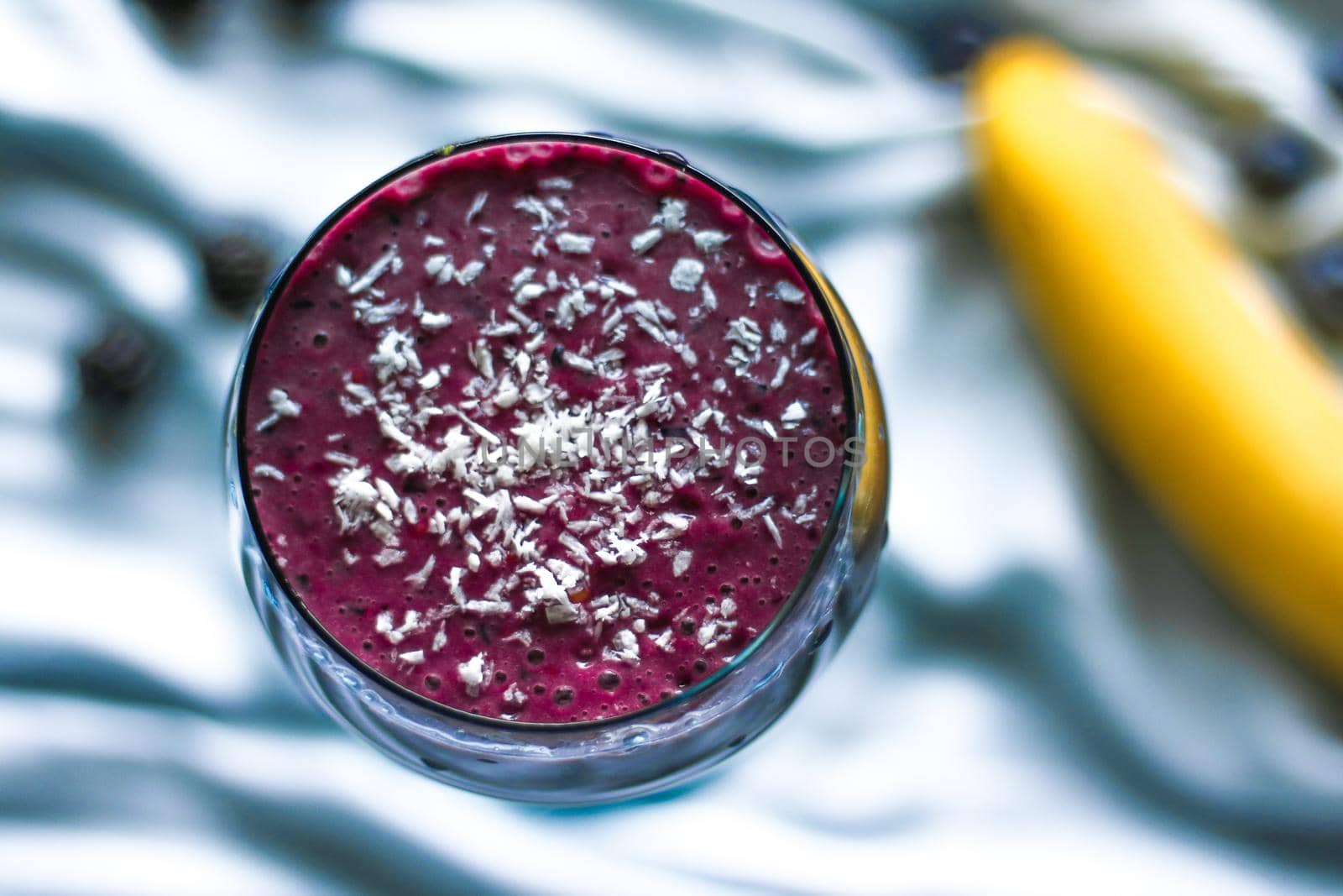 blueberry smoothie with coconut - healthy eating recipe styled concept by Anneleven