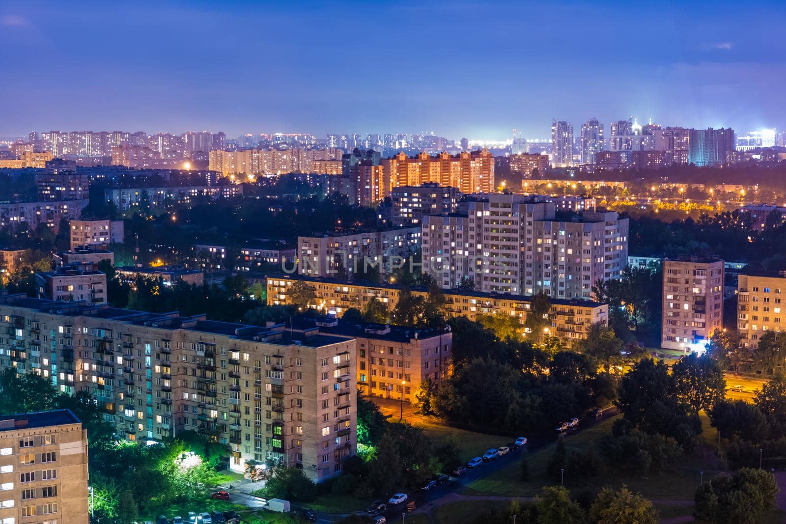 Night colorful windows lights of the high-rise residential building in city sleeping area