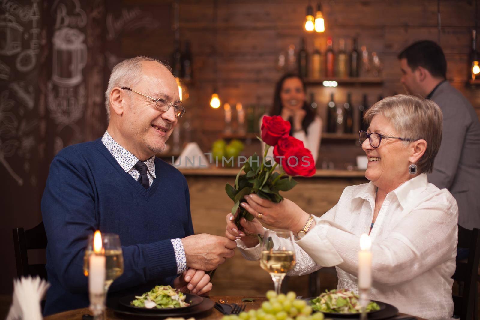 Cheerful senior couple happy about their date by DCStudio