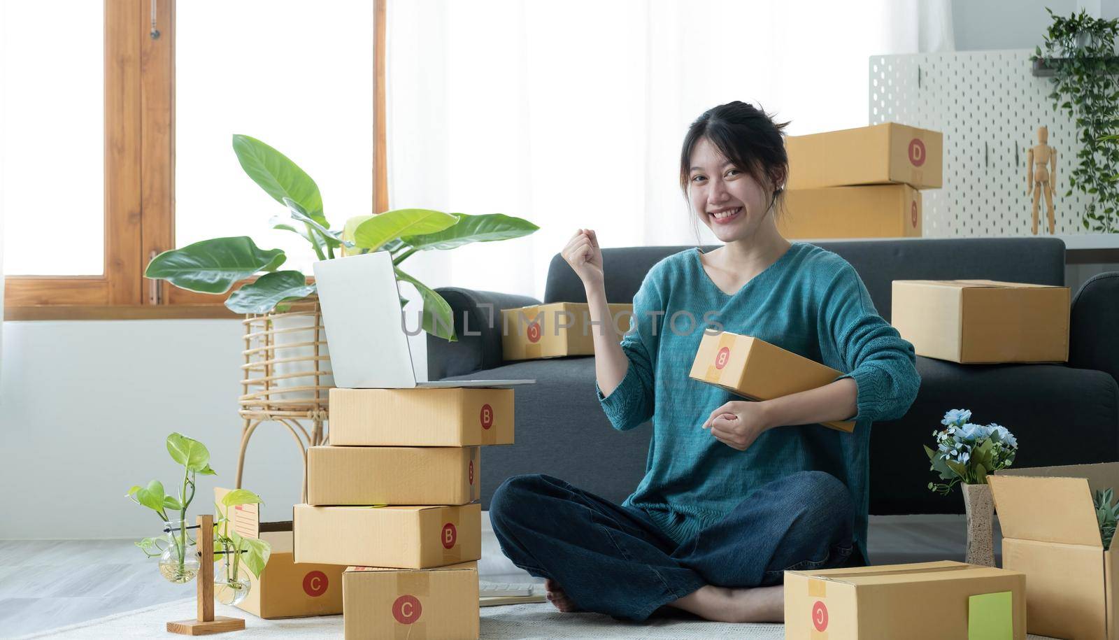 Portrait of Starting small businesses SME owners female entrepreneurs working on receipt box and check online orders to prepare to pack the boxes, sell to customers, SME business ideas online..