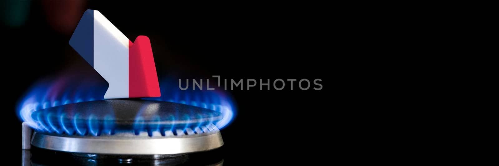 Decreased gas supplies in France. A gas stove with a burning flame and an arrow in the colors of the France flag pointing down. Concept of crisis in winter and lack of natural gas. Heating season