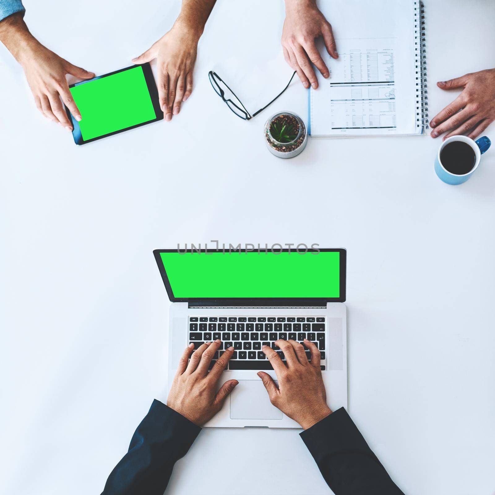 Businesspeople on tablet and laptop with green screen showing marketing, advertising or copyspace from above. Top of hands typing, using wireless tech for online app, website or new modern software.