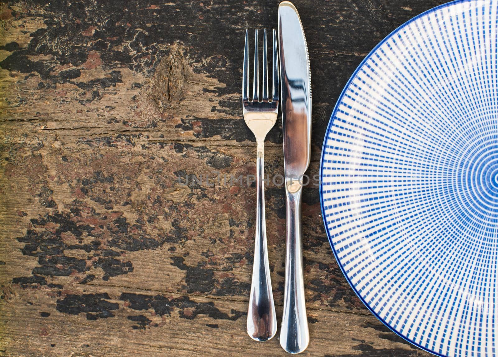 Rustic table setting - vintage silverware and cotton napkin  on dark background with copyspace