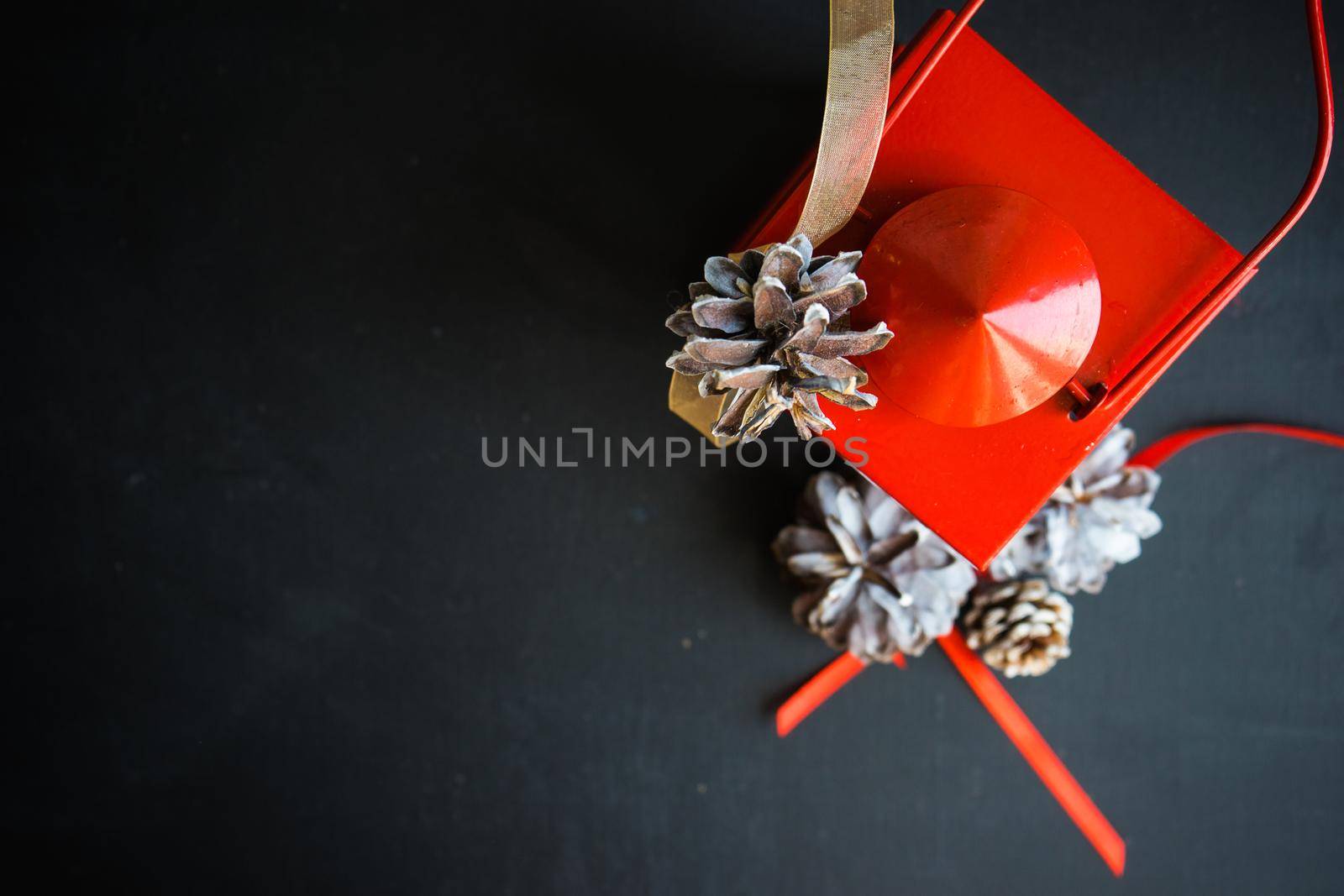 Christmas festive flatlay with cones on darkboard with copyspace