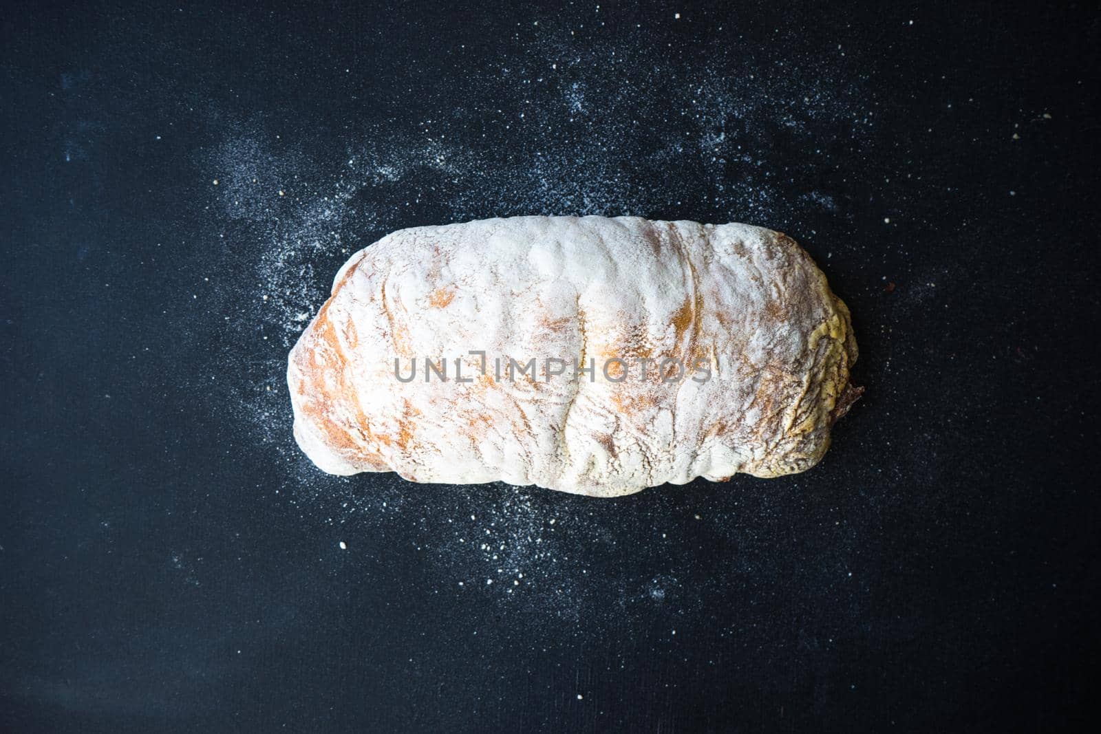 Fresh baked italian bread - ciabatta  on rustic table with napkin