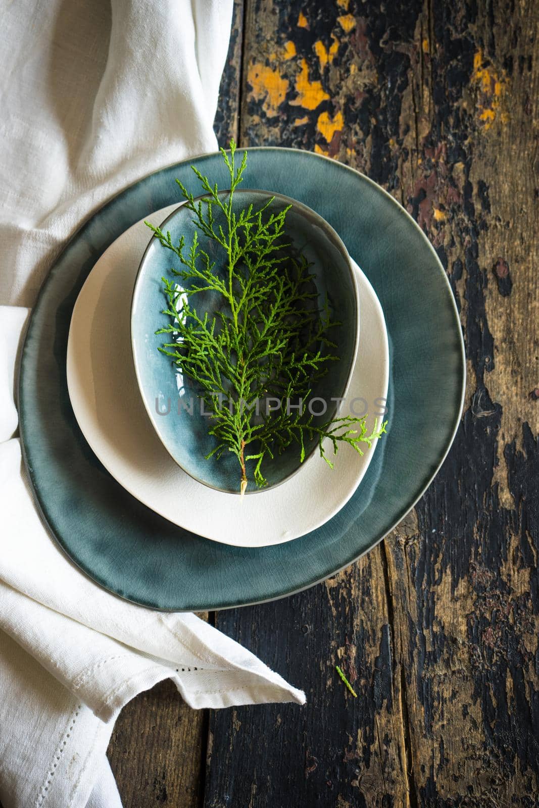 Festive table setting for Christmas dinner on dark rustic table with copyspace