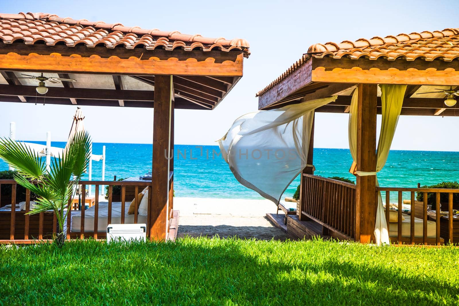 summertime relax on the sand beach with sea waves and beach cabin