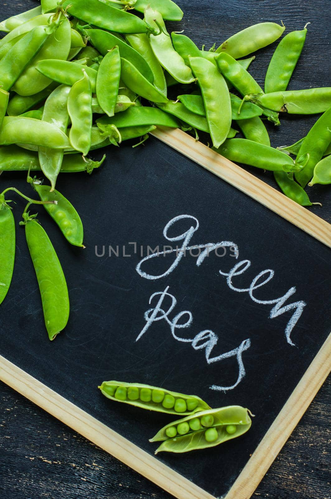 Organic green peas on rustic background