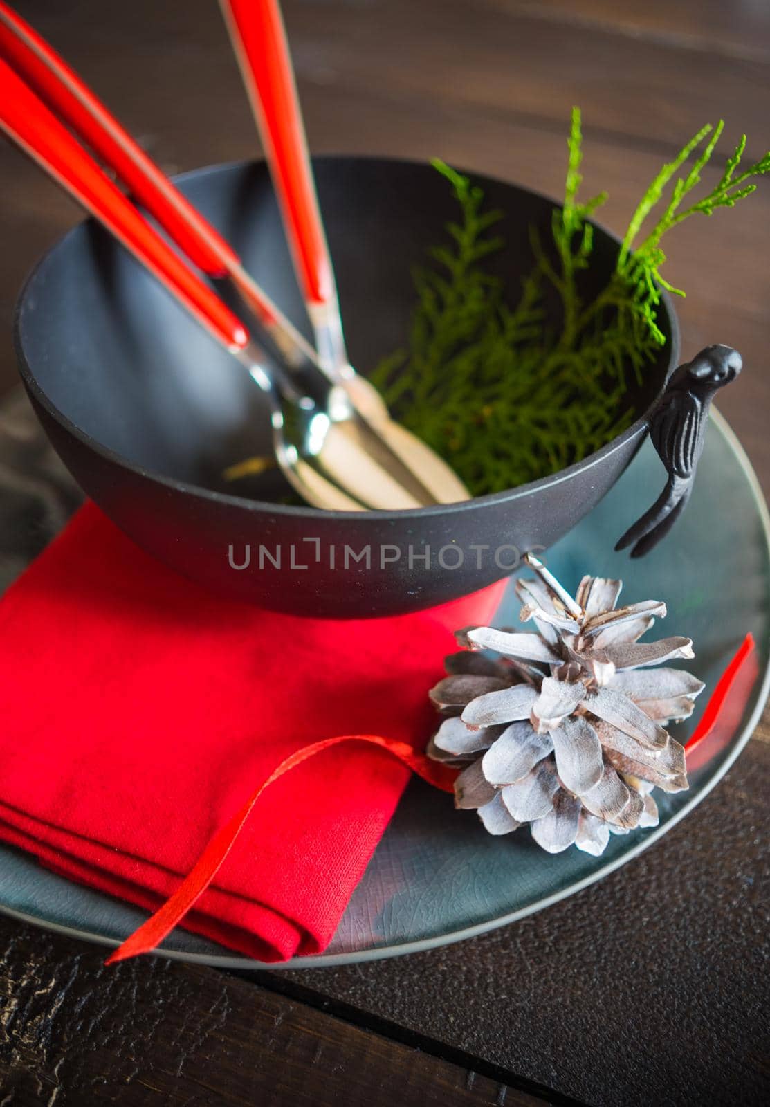 Festive table setting for Christmas dinner on dark rustic table with copyspace