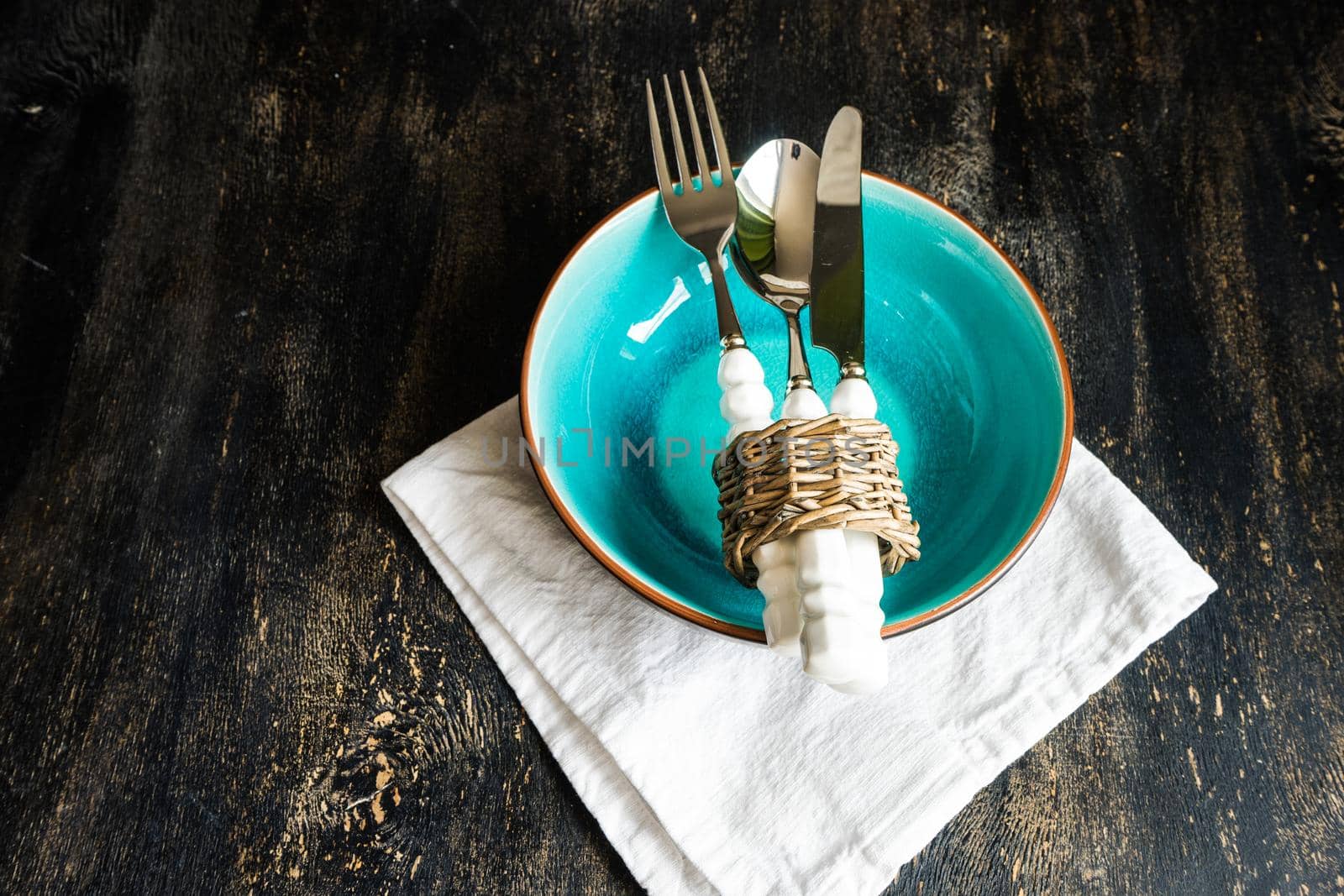 Rustic table setting with vintage tableware   on dark wooden  table with copyspace