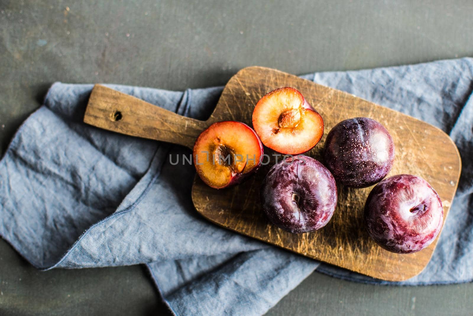 Healthy food concept fresh orgaic plums on a cutting board