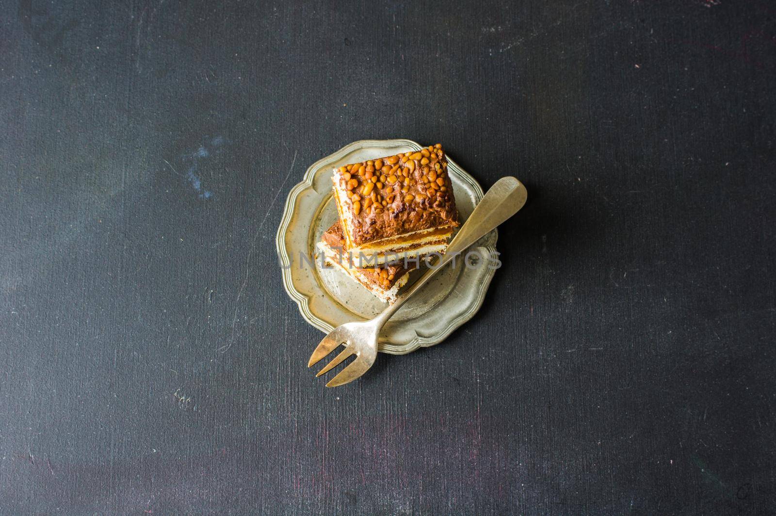 Vanilla and chocolate biscuit cake on rustic wooden table