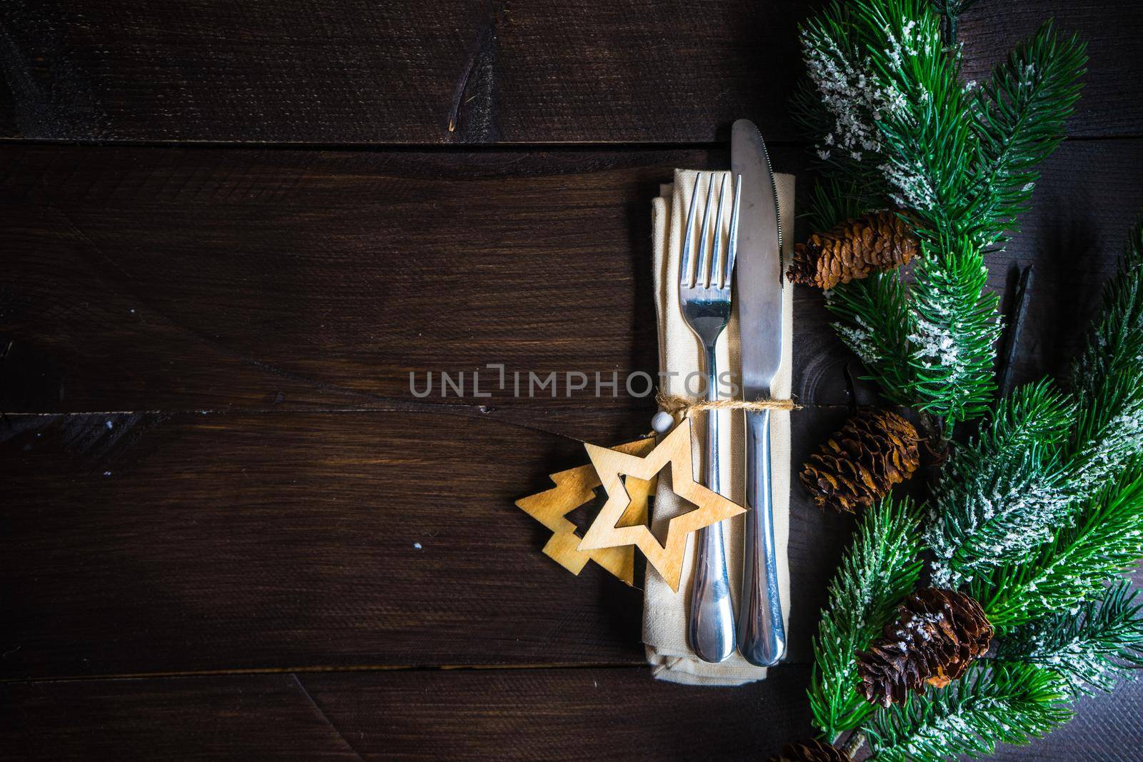 Festive table setting for Christmas holiday dinner with vintage flatware and decoration