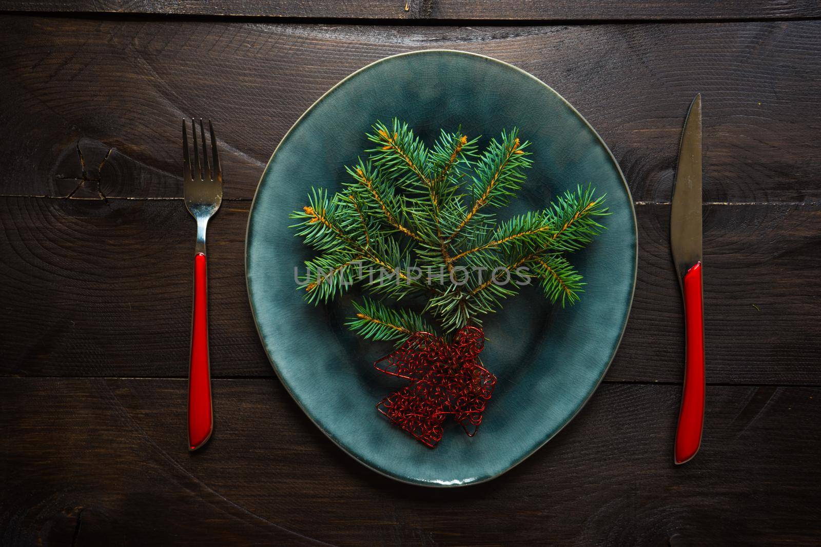 Festive table setting for Christmas holiday dinner with vintage flatware and decoration