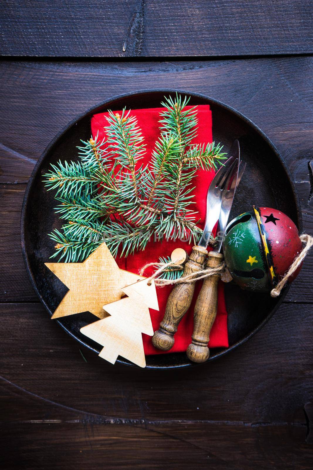Festive table setting for Christmas holiday dinner with vintage flatware and decoration