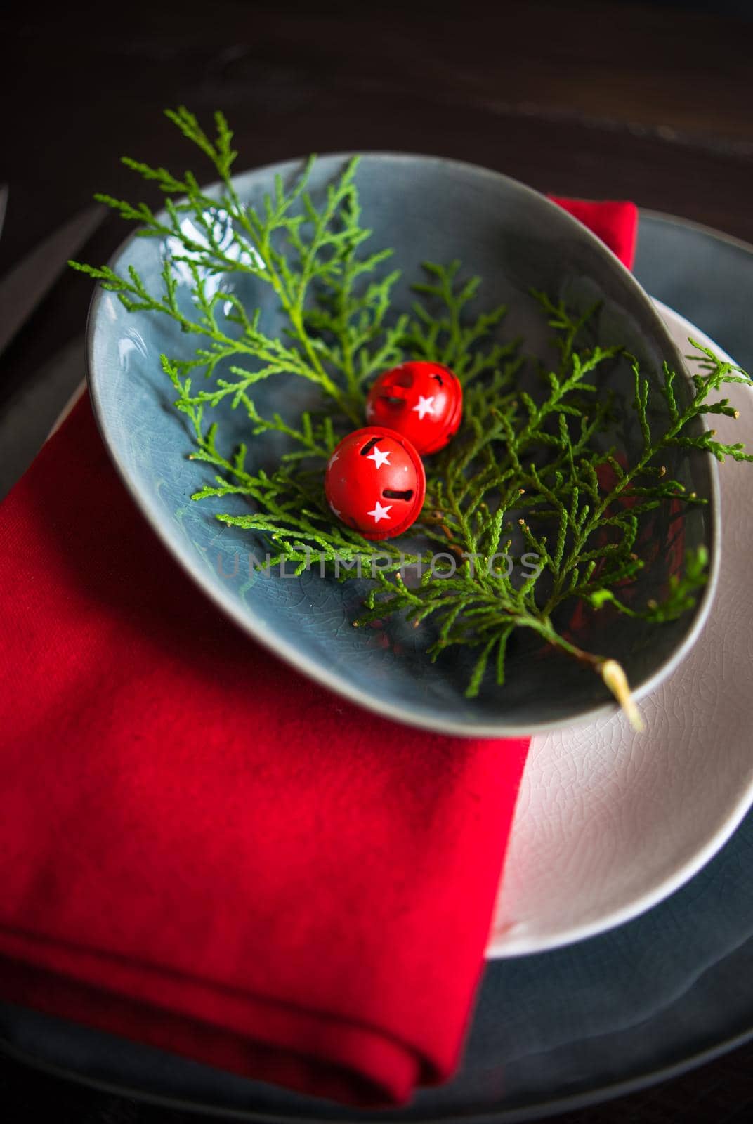 Festive table setting for Christmas dinner on dark rustic table with copyspace