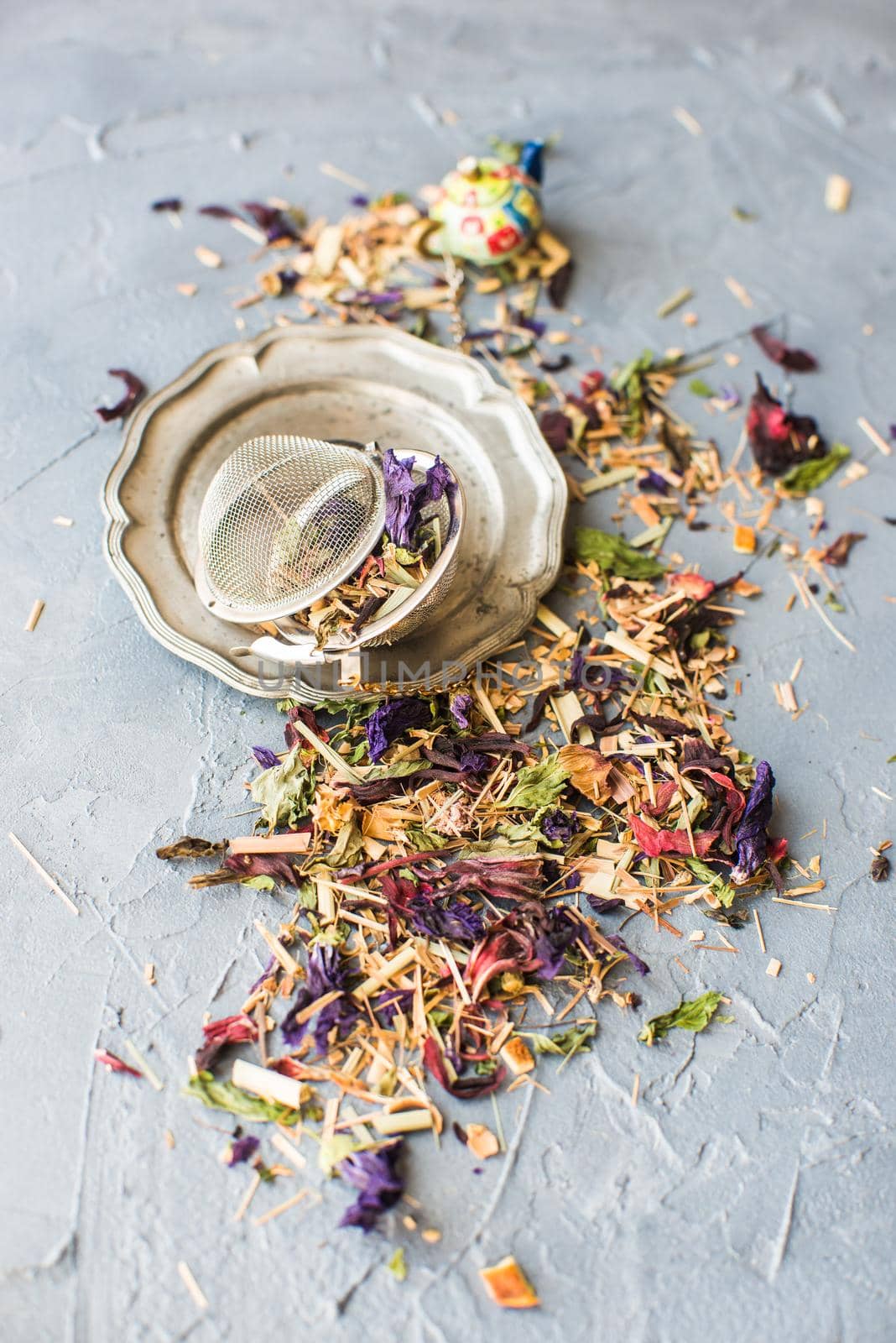 Dry tea leaves with flowersand fruits on wooden background with copyspace as a organic tea concept