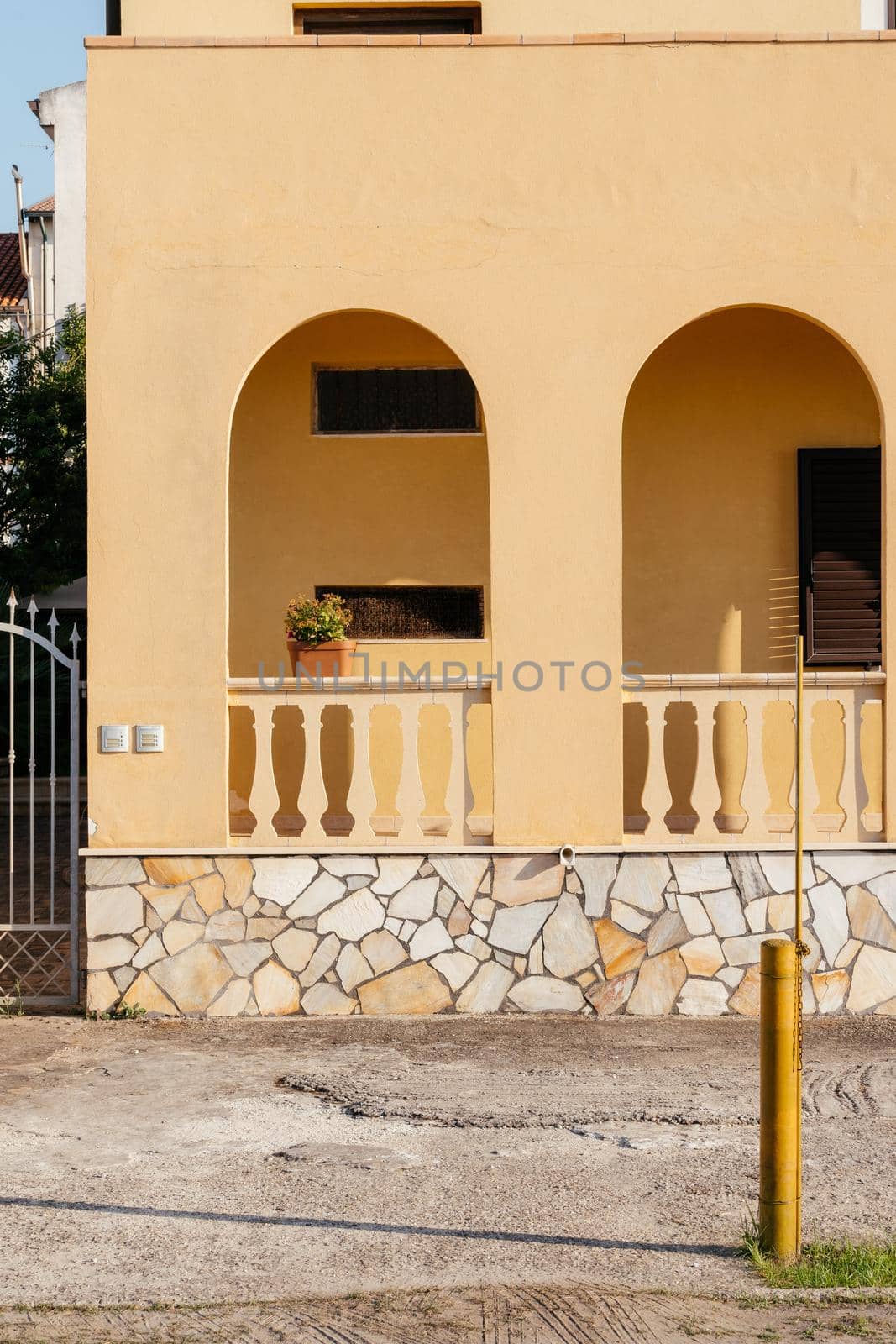 Typical yellow house facade part in italian city near the sea. Mediterranean village style. by photolime