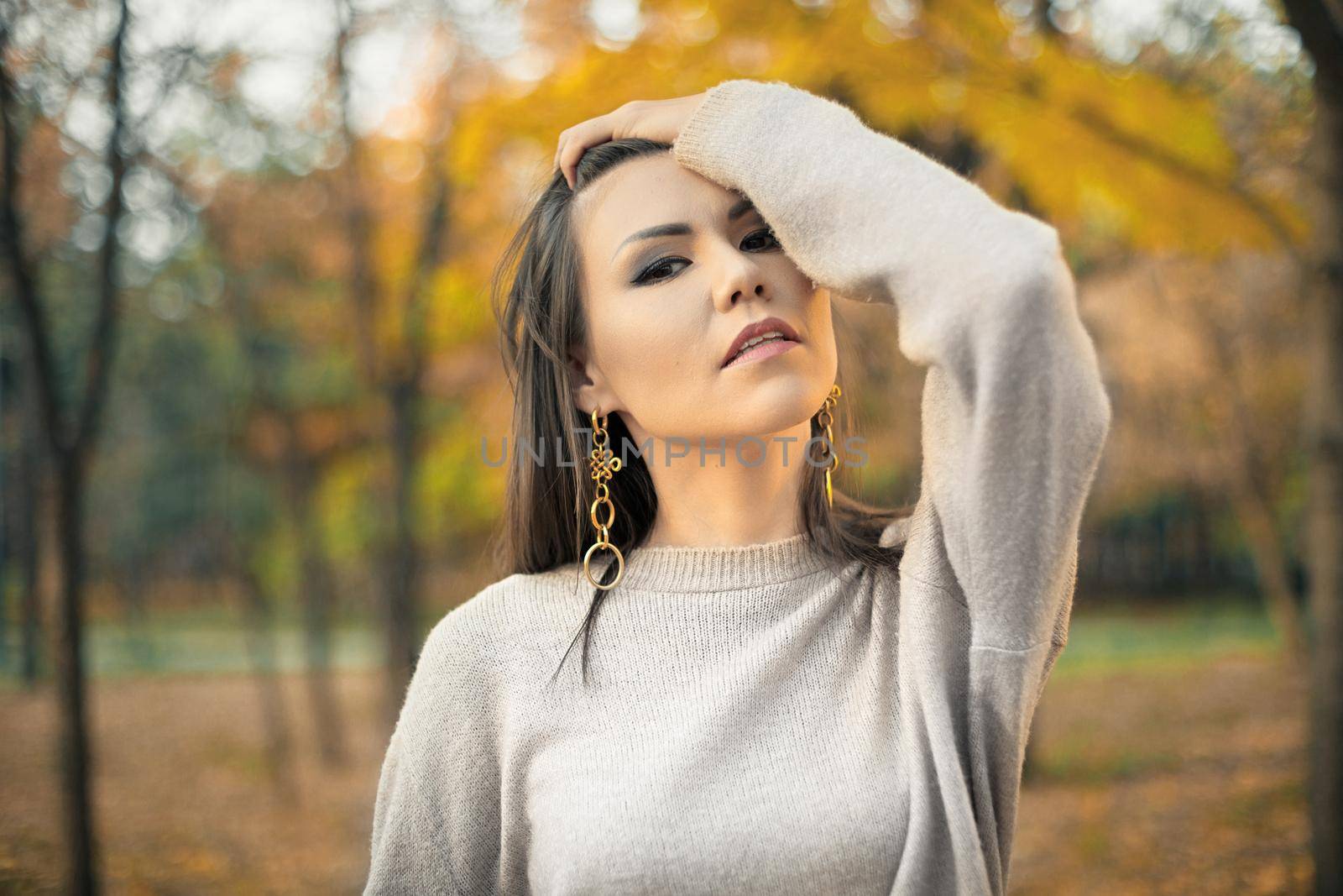 Portrait of a young proud strong and independent mixed race woman against the backdrop of autumn nature.
