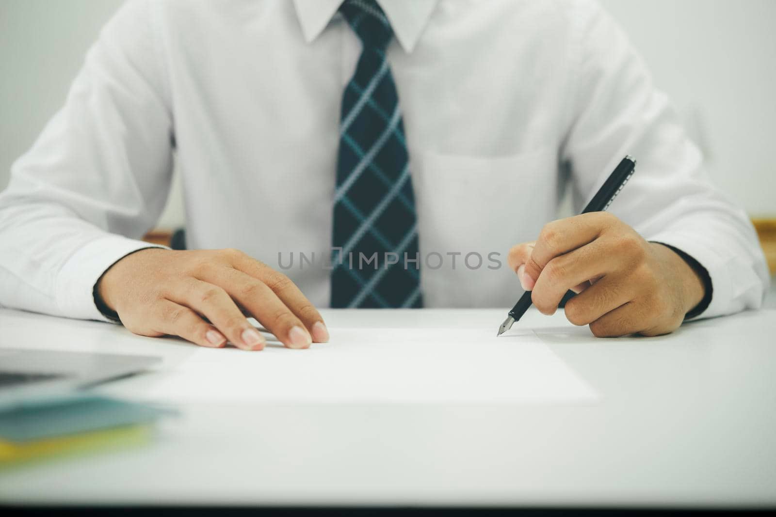 Close up businessman signing contract, partnership agreement, making deal by ijeab