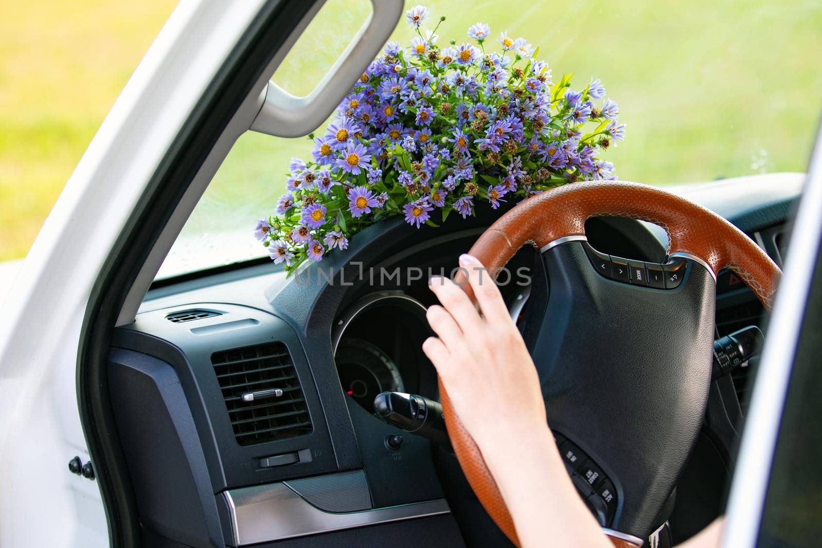Bouquet of wildflowers on a dashboard of a car by Nobilior