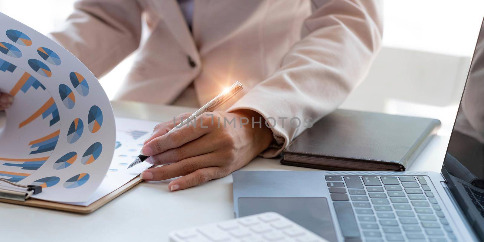 Close up of Business woman investment consultant analysis company annual financial report balance sheet statement working with documents graphs. Concept picture of economy, marketing.